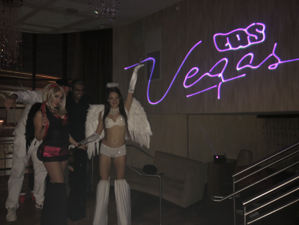 Angel and devil stilt walker entertainers and laser light show in Caesars suite party - Las Vegas, Nevada